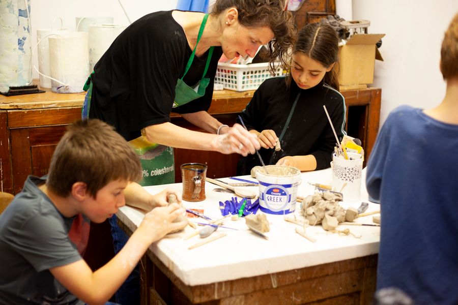 Group of children working in clay with Liz