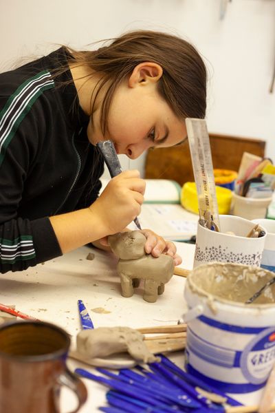 Girl making a clay animal