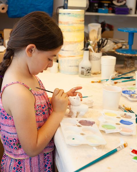 Girl glazing her animal