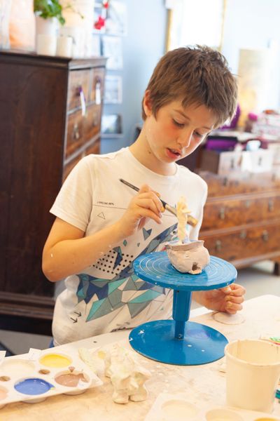 Boy glazing in our shop