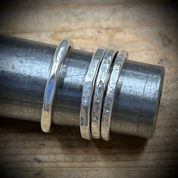 A selection of 4 different silver rings