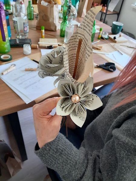 Student holding paper flowers that they made
