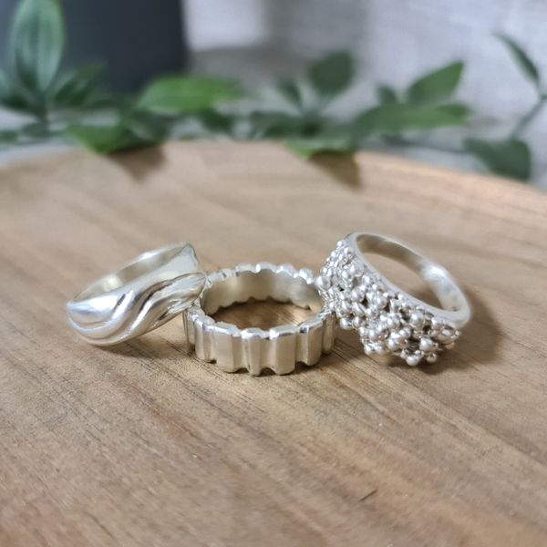 Three rings that have been carved in wax and then cast in sterling silver.