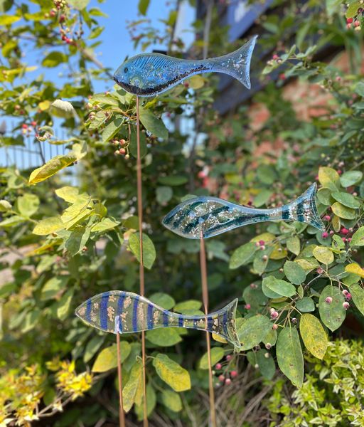 A shoal of fused glass fish in the garden
