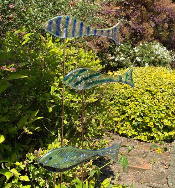 A shoal of fused glass fish in the garden
