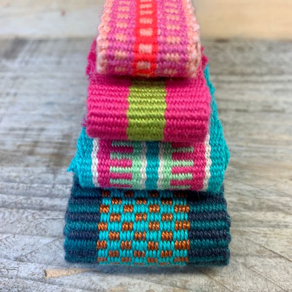 A pile of bands, handwoven on an Ashford inkle loom