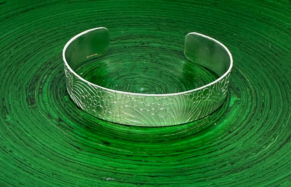 Sterling silver torc bangle with swirl pattern