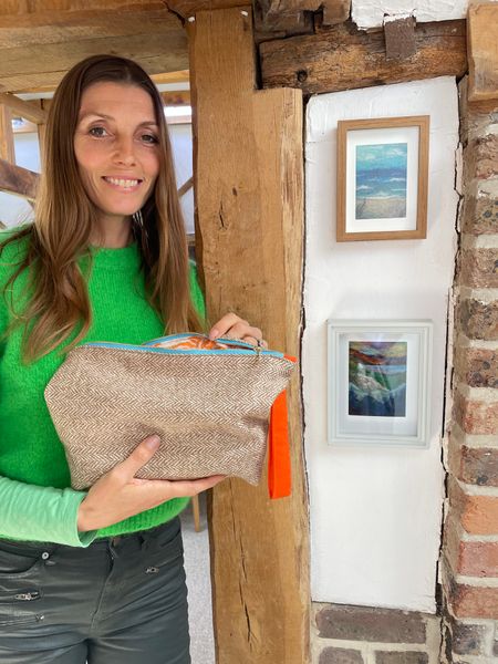 Fiona with her finished  zip bag  next to sone landscapes at The Oast Studio 