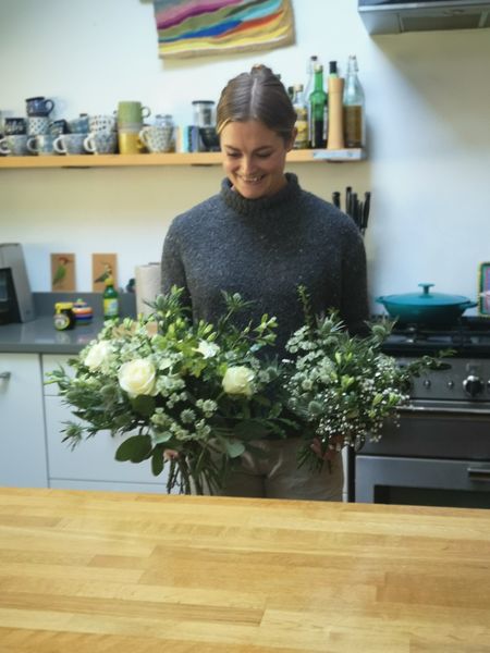 holding two bridesmaids bouquet