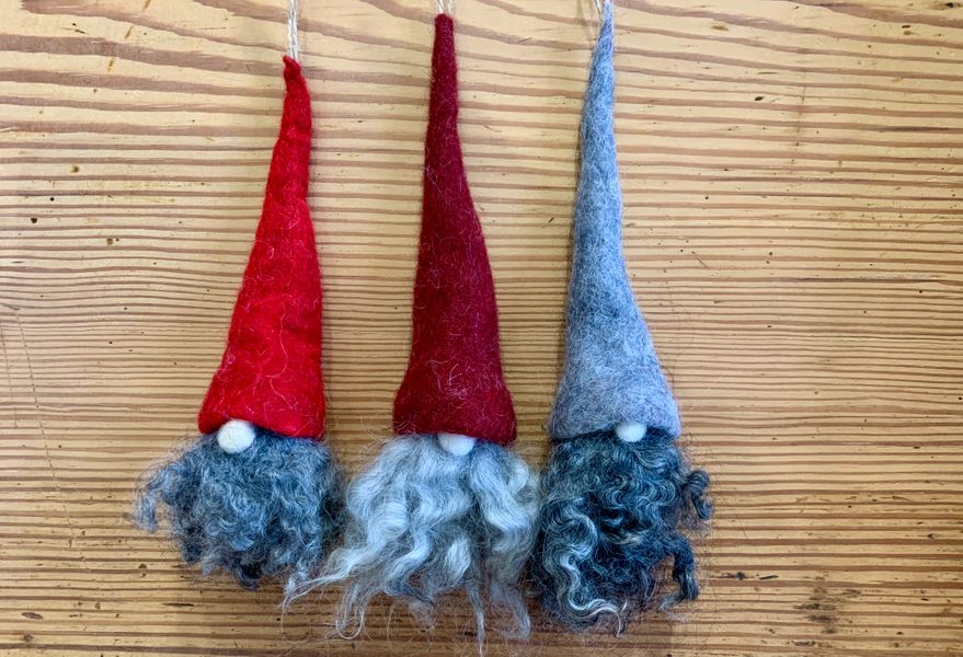 Three Tomte hanging decorations with red, dark red and grey hats and beards in pale and mid grey