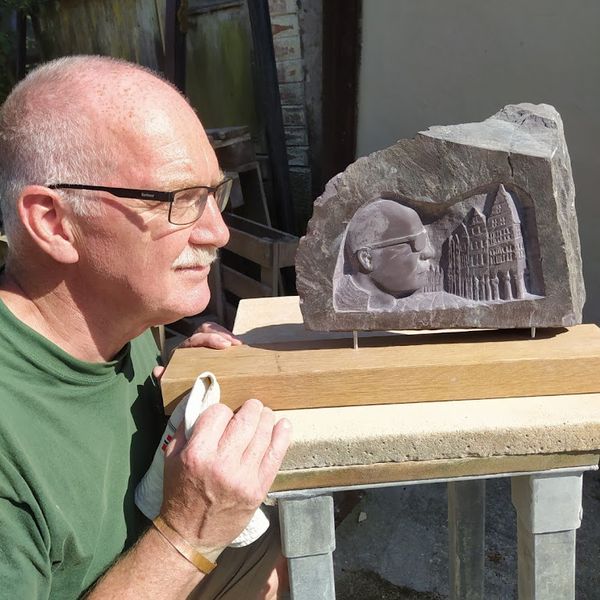 Mike with his self portrait in slate at The Stone Carving Studio