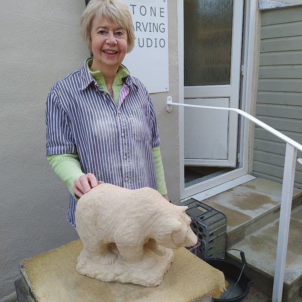 Sheila with her Bath stone sculpture of a grizzly bear