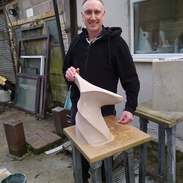 Brent with his abstract whale's tail sculpture made at The Stone Carving Studio