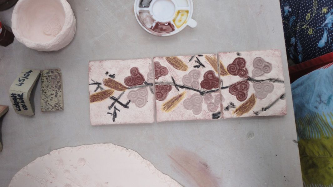 Tile making using oxides to colour designs