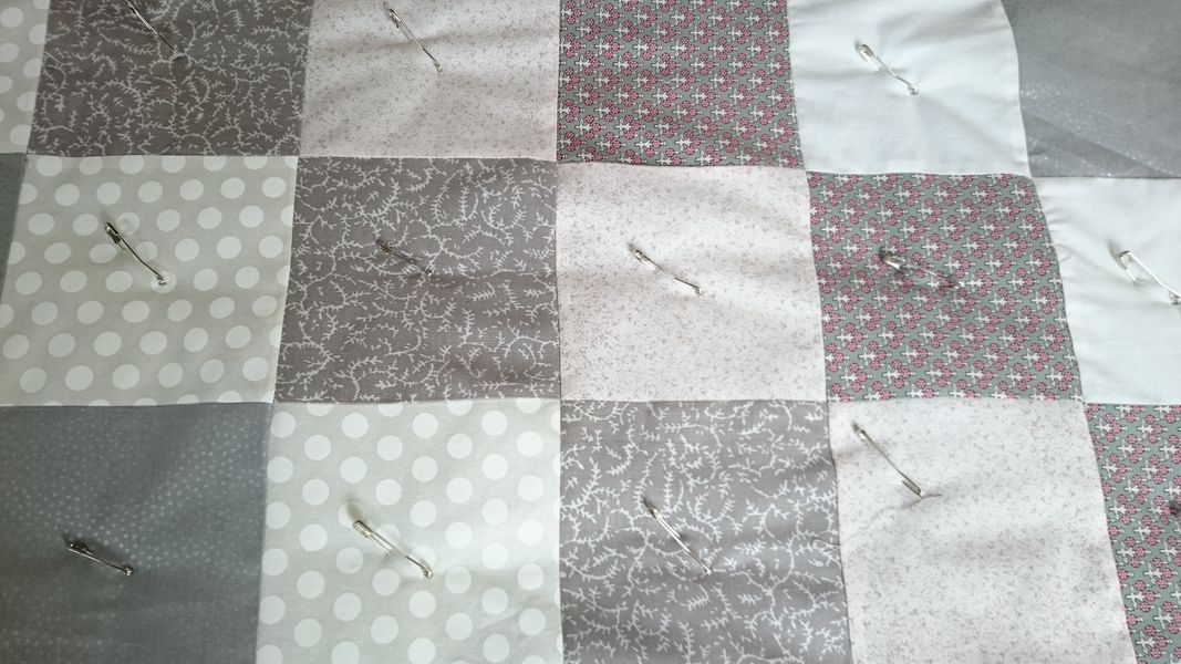 Using quilter's pins to hold the quilt layers
