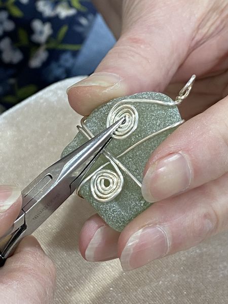 Completing the details of this sea glass pendant