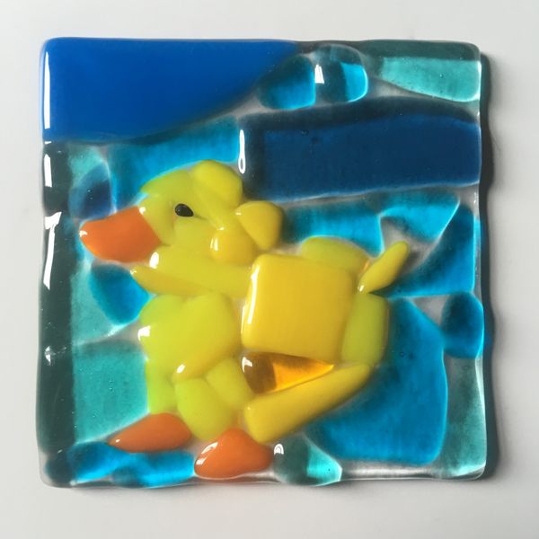Yellow Chick created using precut tiles of glass fused together. 