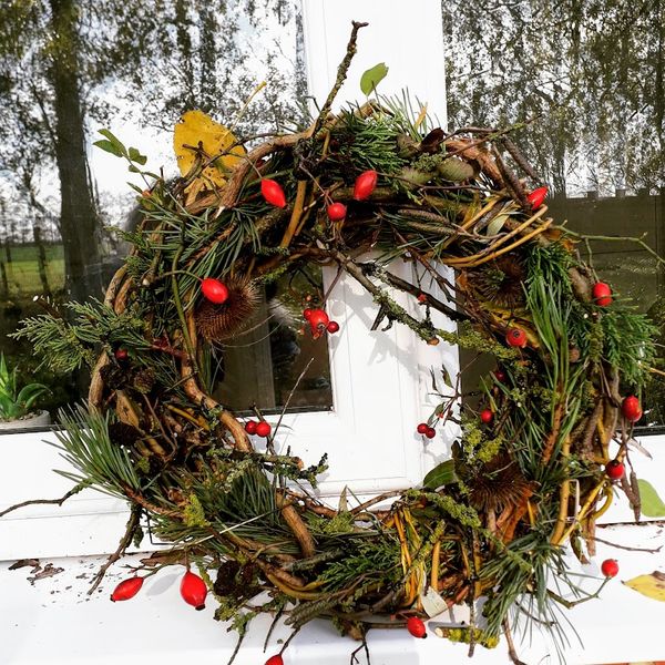Lovely foraged lichen branches, rose hip, berries are features of this lovely wreath