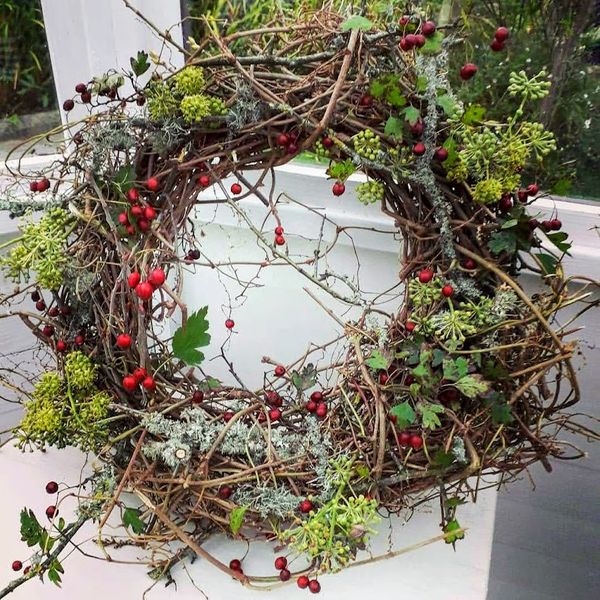 A wreath no less Christmassy, simply decorated to reveal the natural beauty of the woody stems below.