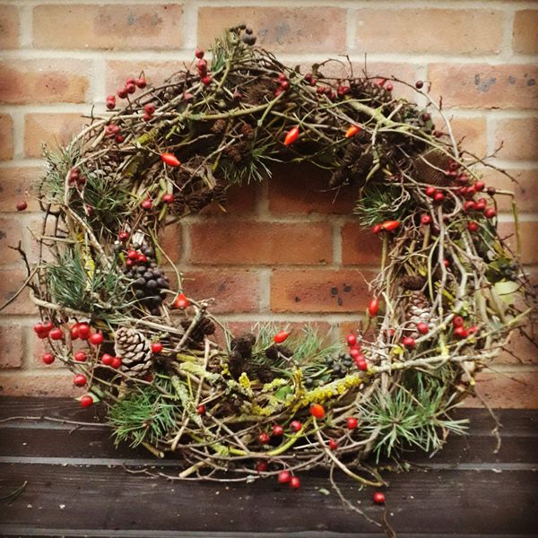 Up the anti and build up the wreath base and leave some of the twisted vines exposed to display the natural beauty of the vines.    Subtly decorated with berries, cones and a touch of pine needles.  Sometimes less is more.