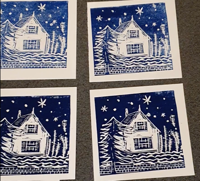 A student's snowy cottage card design