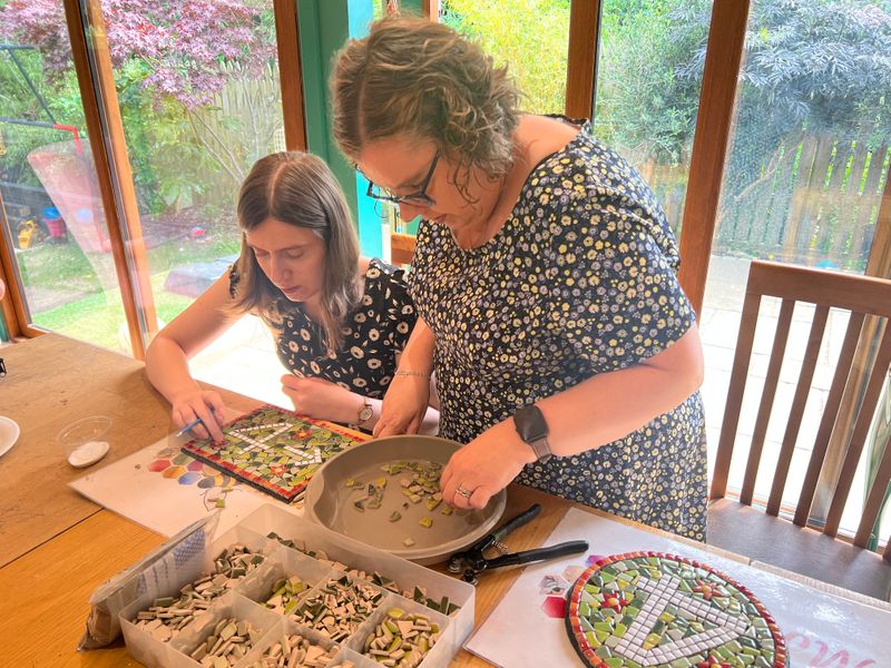 Mother and daughter creating a set of mosaics 