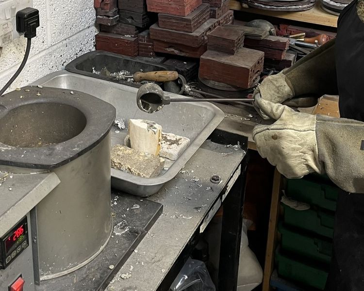 Casting pewter into a cuttlefish mould
