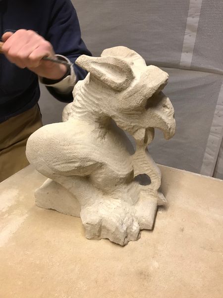 A grotesque being carved at a carving workshop.