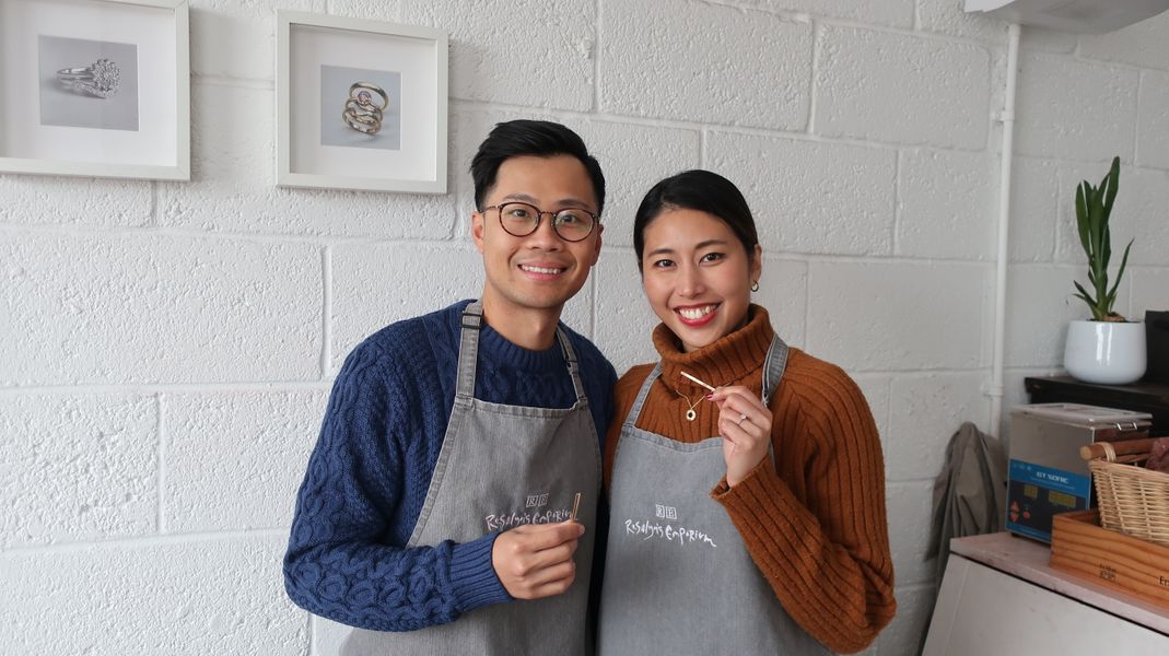 Couple holding bars of gold before making their own wedding rings 