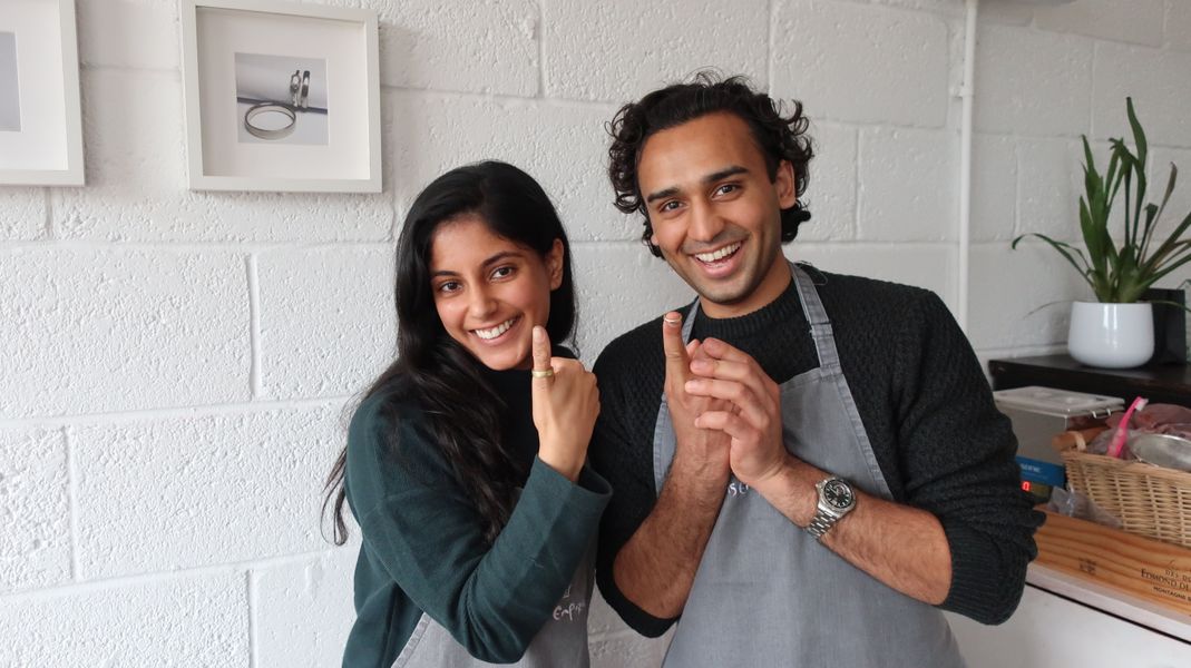 Couple holding the wedding rings they've just made eachother 