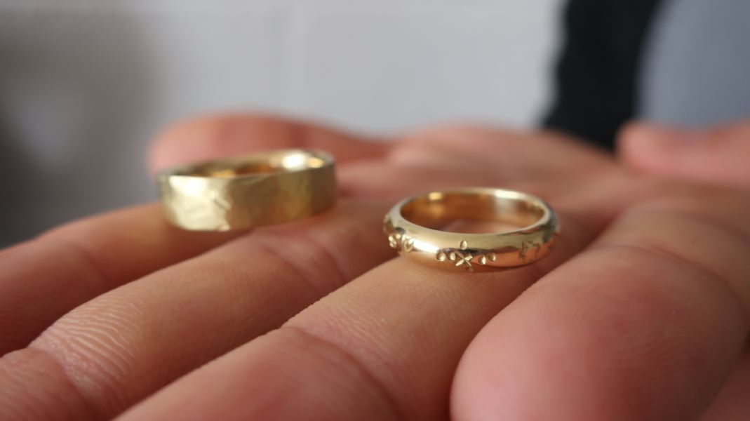 18ct gold handmade wedding rings with stamped design and texture 