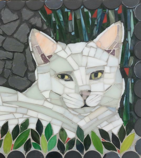 White cat in stained glass and slate.