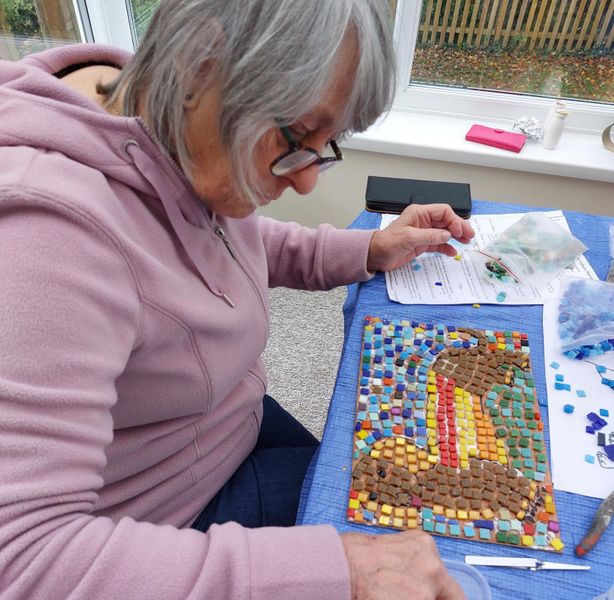 Making a mosaic of her much loved dog.