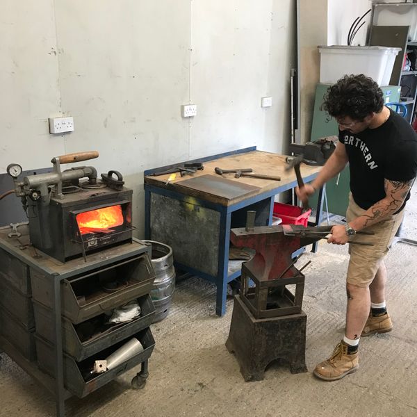 Forging with a gas forge and anvil in the workshop